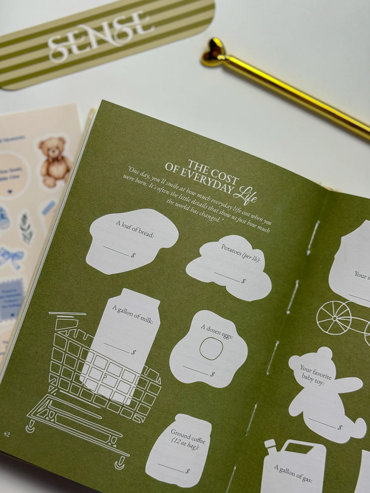 Spread of the English-edition baby memory book with the page about prices in the birth year
