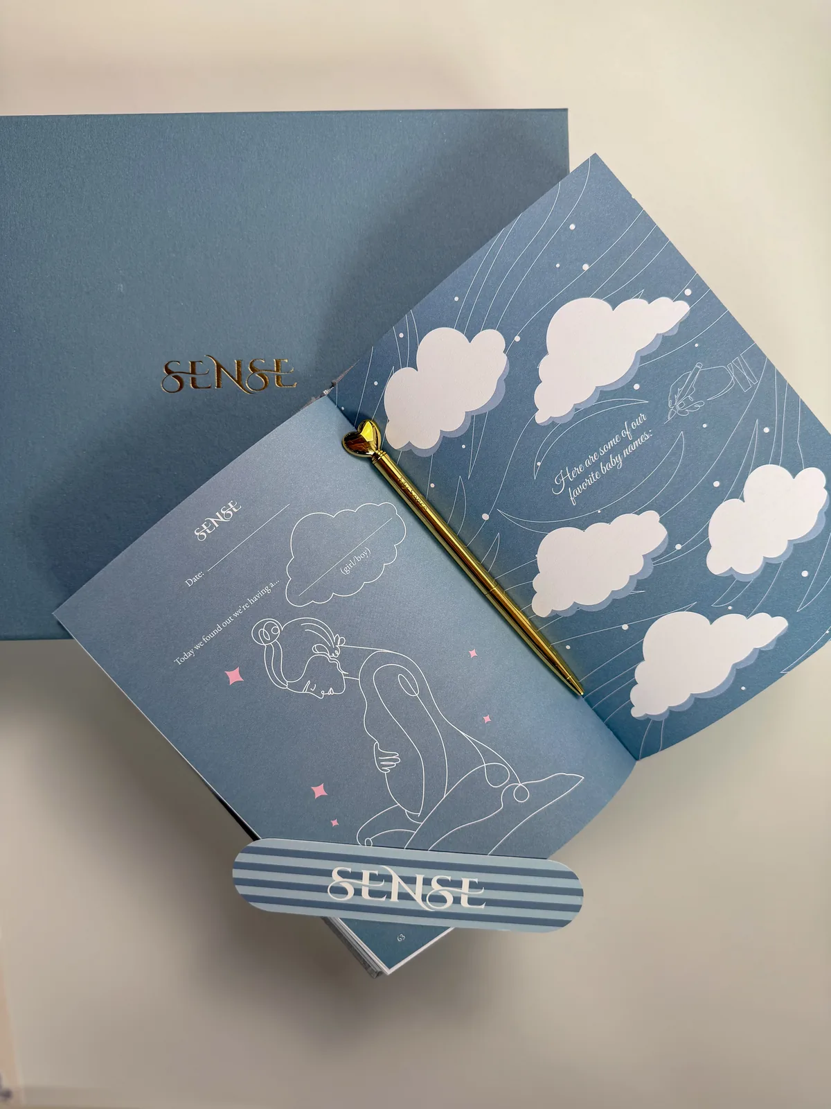 Spread of the English-edition pregnancy journal on the light-blue box