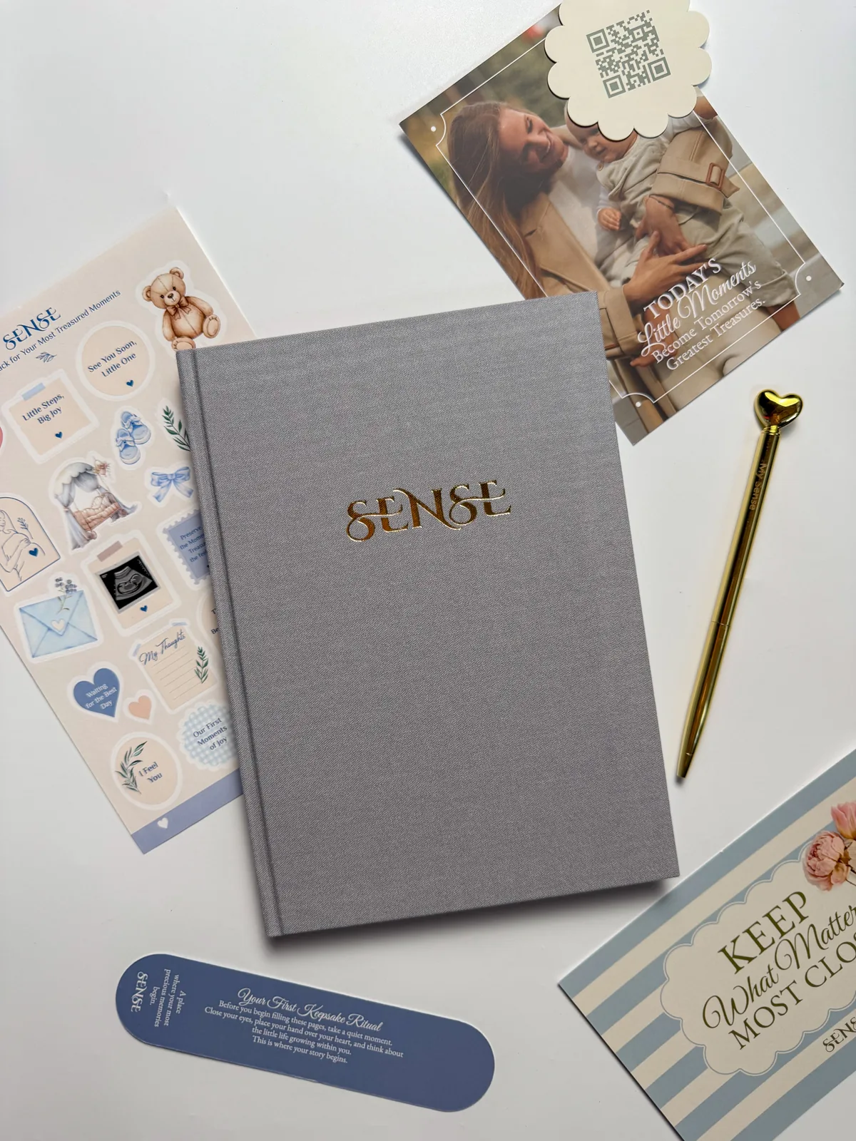Grey English-edition pregnancy journal with a gold pen and a card